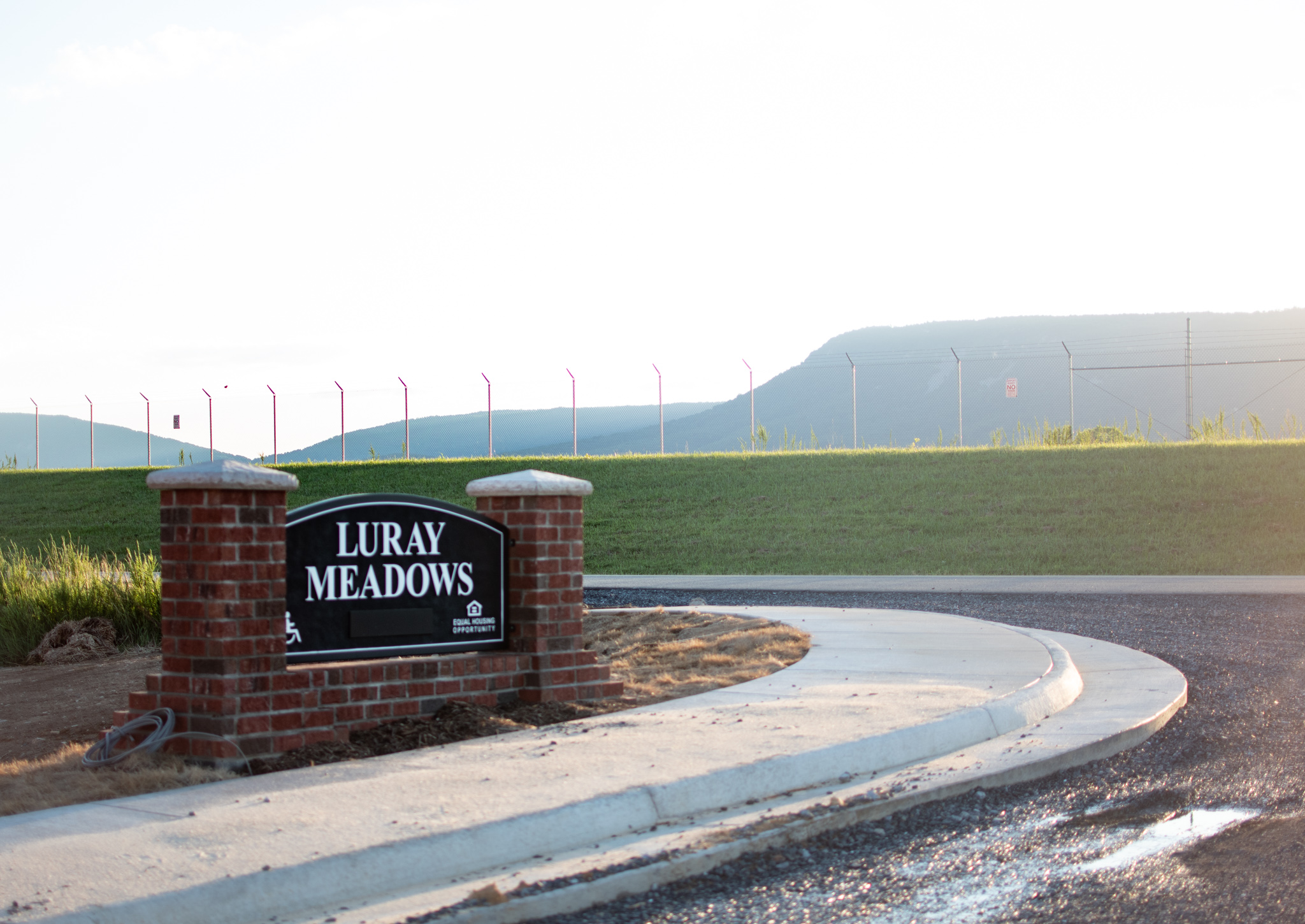 A sign with mountains in the background