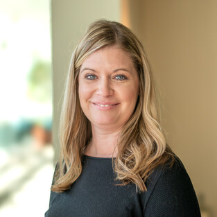 Headshot of a white woman with blonde hair